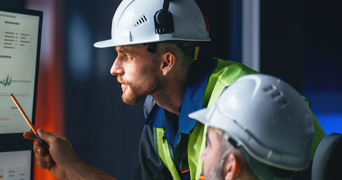 Two engineers looking at a computer screen