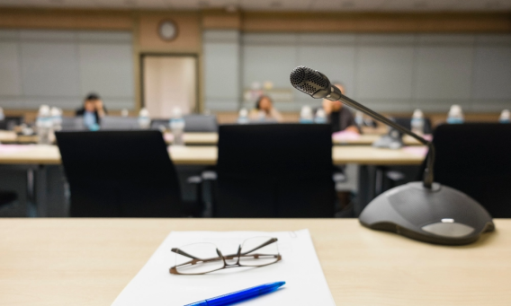 Male working on his laptop surrounded by books and notepads. 