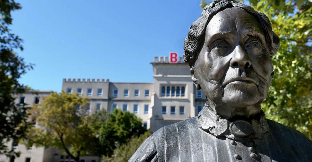 Statue of Lydia Moss Bradley in front of a Bradley Campus building.